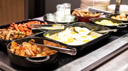 Fried and scrambled eggs and omelette station in a hotel or restaurant setting, catering breakfast