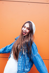 young pretty teenage girl posing cheerful happy smiling wearing street style outside in europe city, lifestyle people concept