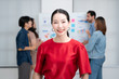 © Monster Ztudio - Confidence team leader. Young women asian owner startup business looking camera with smile while his colleagues working in the background