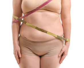 Wall Mural - Overweight woman with measuring tapes on white background, closeup. Weight loss concept