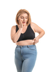 Troubled overweight woman on white background. Weight loss concept