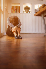 A young businesswoman sits on the floor in agony alone, as the business invested has a problem during the coronavirus covid-19 epidemic.The concept of pain and regret from business failure