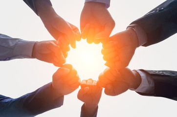 Close up image of successful team join  hands up   to the sky ,round  shape for achievement  target ,collaboration and close relationship on isolated white background, sun light ,teamwork concept,