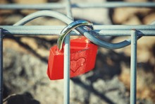 Close-up Of Red Love Lock Hanging On Railing
