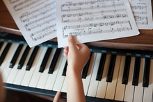 Close-up Of A Child's Hand Playing The Piano . Favorite Classical Music. Musical Instruments For Teaching Music At Home. The Concept Of A Musical Instrument. Self-education