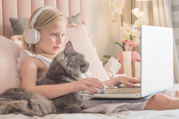 Online remote learning. School kids with computer having video conference chat with teacher and class group. Child studying from home. Homeschooling during quarantine and coronavirus outbreak.