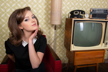 Portrait Of Camera And Happy Smiling In Room With Vintage Wallpaper And Interior, Retro Stylization 60-70s. Furniture, Tv Set And Another Technique Of 20th Century