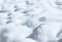 Pure Snow. Bumpy Snowdrift Background With Perspective And Bluish Tint Close Up.