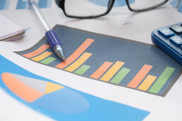 Close up of financial chart and pens on table 