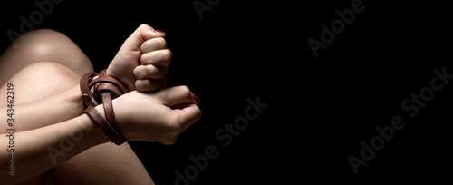 Fotografía Woman tied up with leather belt in emotional stress and pain