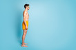© deagreez - Full length body size profile side view of his he nice attractive content guy in swimming shorts spa resort hotel trip isolated on bright vivid shine vibrant green blue turquoise color background