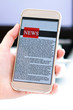 © Elena - Online news on a mobile phone. Close up of businesswoman reading news or articles in a smartphone screen application. Hand holding smart device. Mockup website. vertical photo