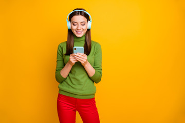 Poster - Portrait of positive cheerful girl have weekends use smartphone listen music blue wireless headset choose stereo radio playlist wear stylish clothes isolated shine color background