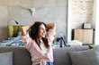 © F8  \ Suport Ukraine - Resting with joy. Beautiful young woman listening to music while sitting on sofa at home