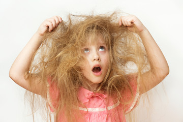 Wall Mural - a little girl with tangled long hair in a pink dress on a white background. a portrait with an open 