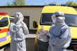Ambulance experts put on protective suits for trips to places of infection of people.