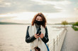 © Катя Іваськевич - young woman with mobile phone in the city in mask. coronavirus. covid-19.