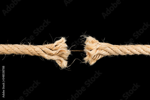 Fotomural Frayed rope sting break torn isolated on black backgroud stress weakness concept