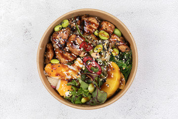 Wall Mural - Poke bowl with chicken and vegetables on the white table.