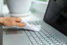Electronics Disinfection And Hygiene - Hand Cleaning Laptop Keyboard With Antibacterial Wet Wipe