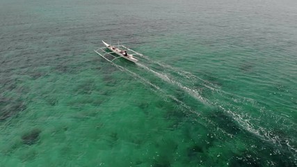 Wall Mural - Flying over fisherman's boat next to Bantayan island, Cebu, Philippines