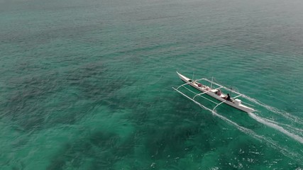 Wall Mural - Flying over fisherman's boat next to Bantayan island, Cebu, Philippines