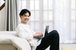 © Gengwit - Attractive asian male working with computer laptop at home. Work from home concept.