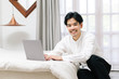 © Gengwit - Attractive asian male working with computer laptop at home. Work from home concept.