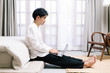 © Gengwit - Attractive asian male working with computer laptop at home. Work from home concept.