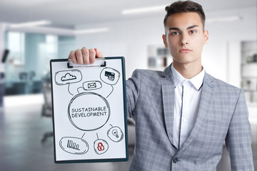 Wall Mural - Business, Technology, Internet and network concept. Young businessman working on a virtual screen of the future and sees the inscription: Sustainable development