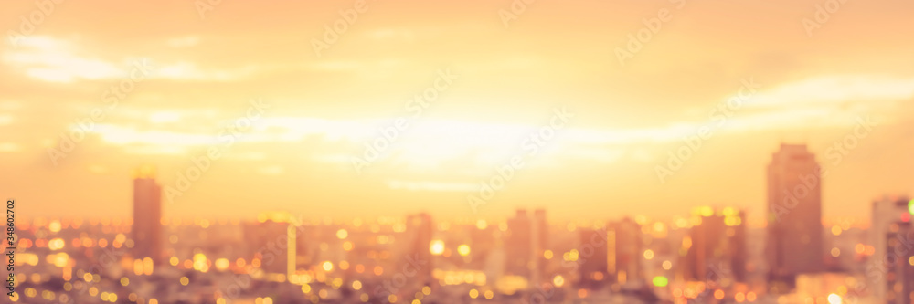 Rooftop party blur city background of blurry sunrise or happy golden hour sunset evening with heatwave, sunmmer sun heat wave, and cityscape buildings skyline backdrop for June Solstice - obrazy, fototapety, plakaty 