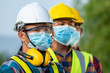 © visoot - Workers wear protective face masks for safety working at solar power station,Coronavirus has turned into a global emergency.