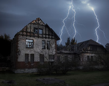 A Horror Scene Of An Old Haunted British Style 19th Century Countryside House In The Night During Thunder Lightning