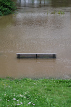 High Angle View Of Bench Amidst Flooded Water At Park