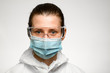 © fesenko - young woman in medical mask and goggles for protection against influenza.