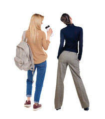 Canvas Print - Back view of two woman in sweater.