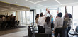 © Martin Barraud/Caia Image - Business people cheering in huddle in office meeting