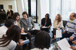 © Martin Barraud/Caia Image - Business people talking in circle in conference room meeting
