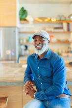 Portrait Smiling, Carefree Man With Beard In Kitchen