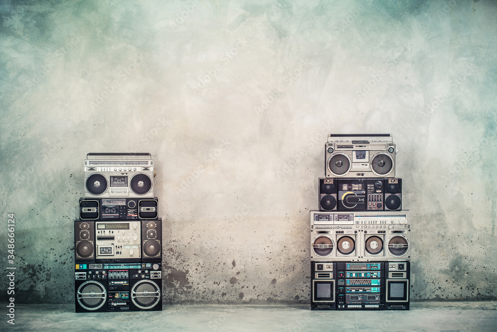 Retro old design ghetto blaster boombox radio cassette tape recorders from 1980s front concrete street wall. Nostalgic Rap, Hip Hop, R&B music concept. Vintage style filtered photo - obrazy, fototapety, plakaty 