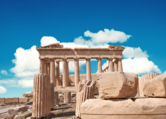 Fototapete - Parthenon temple on a bright day with blue sky and clouds. Panoramic image of ancient buildings in Acropolis hill in Athens, Greece. Classical ancient Greek civilization landmark, travel background.
