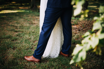 Wall Mural - photo of wedded couple standing in a green garden