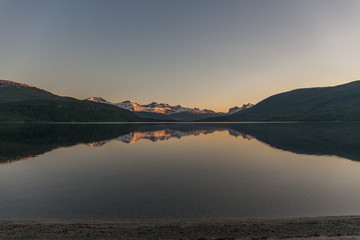 Wall Mural - Beautiful view of the Norwegian fjords with turquoise water surrounded by cloudy sky, selective focus, Photo taken at midnight sun