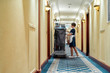 A tradition of quality cleaning. Full-length shot of hotel maid in uniform standing in front of chambermaid trolley with fresh towels. Room service concept.