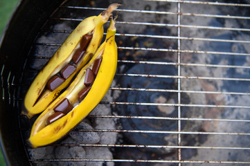 Two ripe grilled bananas with chocolate. Selective focus.