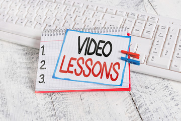 Poster - Text sign showing Video Lessons. Business photo showcasing Online Education material for a topic Viewing and learning notebook paper reminder clothespin pinned sheet white keyboard light wooden
