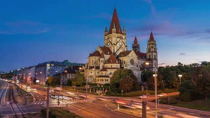 Wall Mural - Day to night time lapse view of historical landmark St Francis of Assisi Church aka Mexico Church on Mexikoplatz in Vienna, Austria, zoom out.