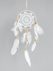 Wall Mural - White dreamcatcher at gray background. Interior decoration. Native American Dreamcatcher