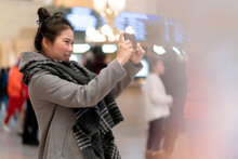 Attractive Beautiful Asian Female Woman Travel Alone Enjoy Sight Seeing And Look For Direction In Grand Central Terminal With Crowd People Blur Background Rush Hour Moment