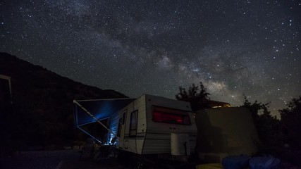 Wall Mural - Stars Starry Night Sky Milky Way over an RV Camper Time Lapse
